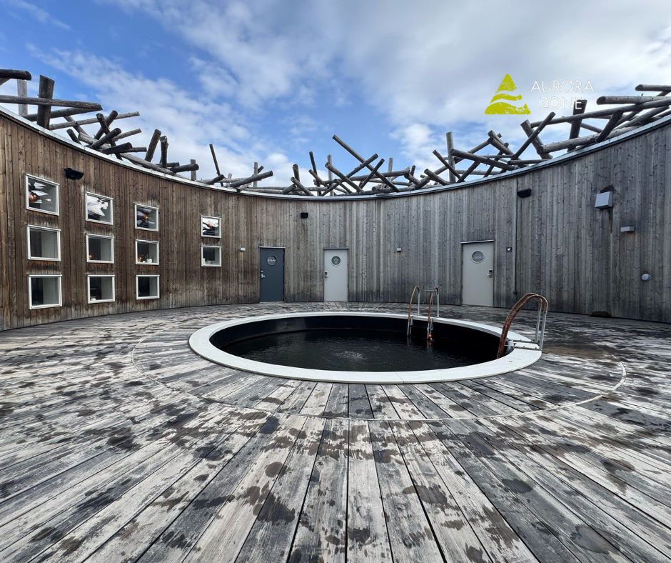 Arctic Bath in Swedish Lapland with a circle pool in the middle of a decked area.